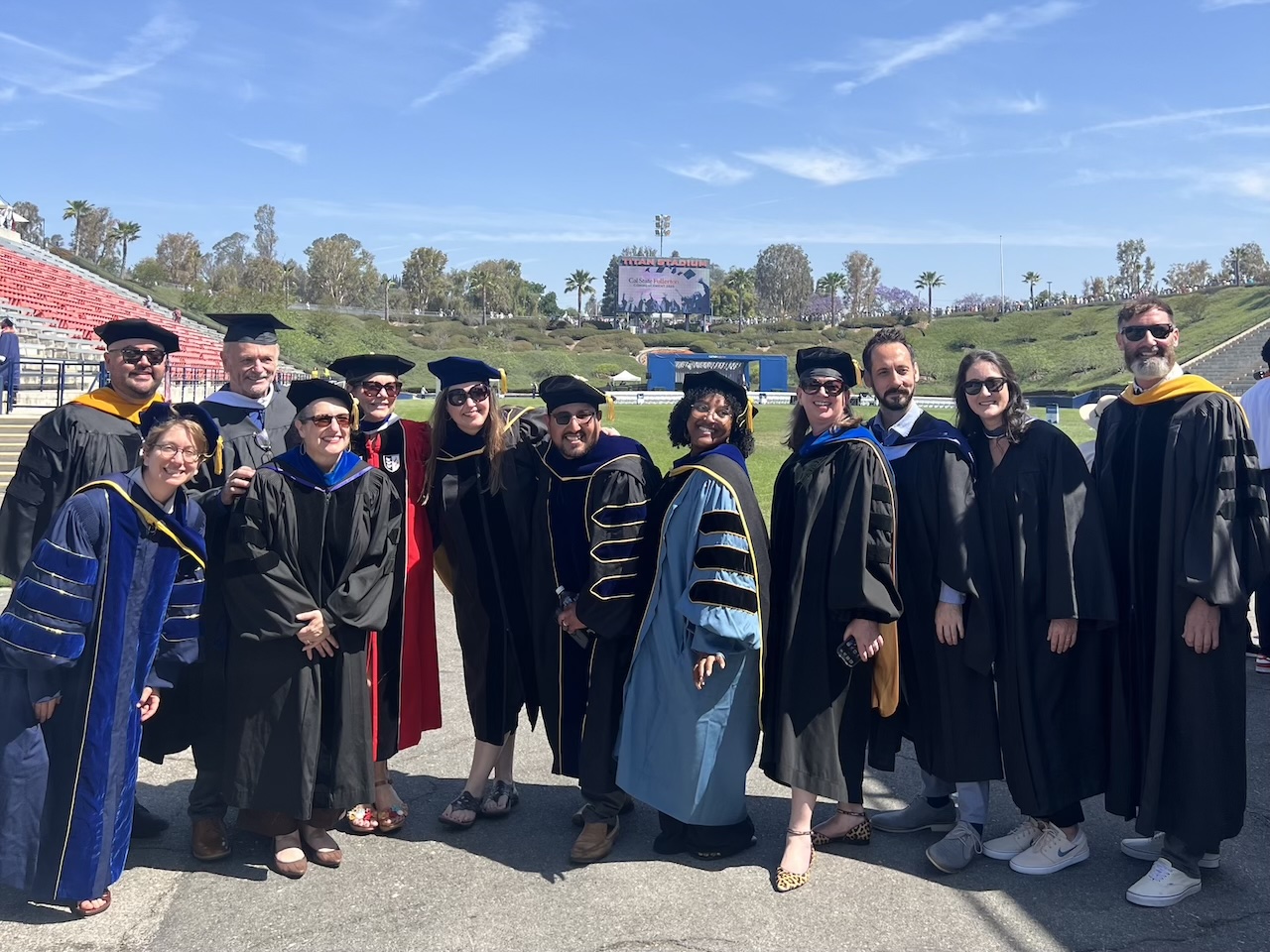 Twelve Psychology faculty members in their respective graduation robes at Commencement 2025